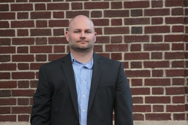 Troy Shimkus seated, hands together